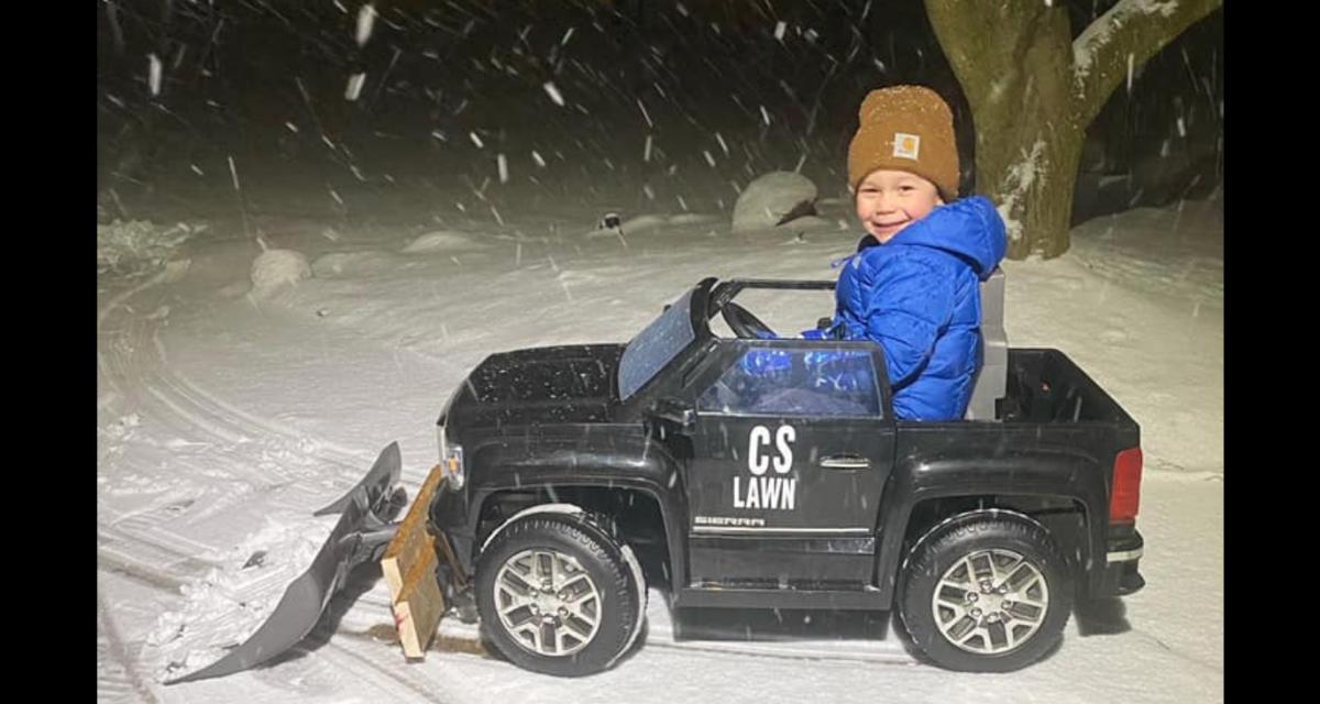 Comment rendre son fils de 4 ans utile en pleine tempête de neige ? Ajoutez  une pelle à sa voiture électrique